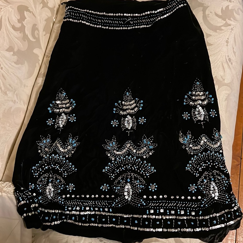 Long black skirt with design at the bottom of it
